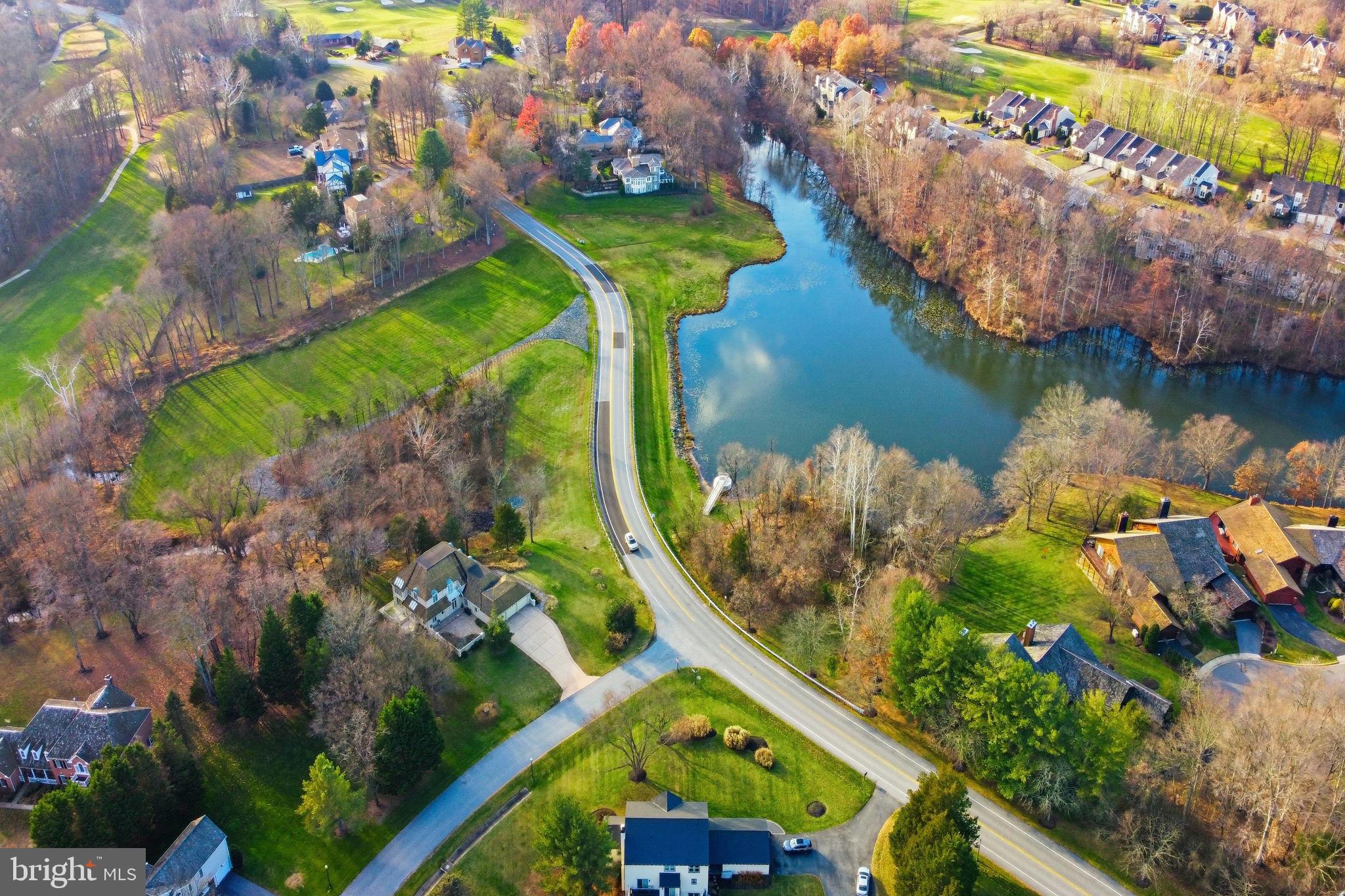 12302 Prospect Landing Bowie, MD 20721 - Photo 103 of 104 an aerial view of a house a yard and a lake view