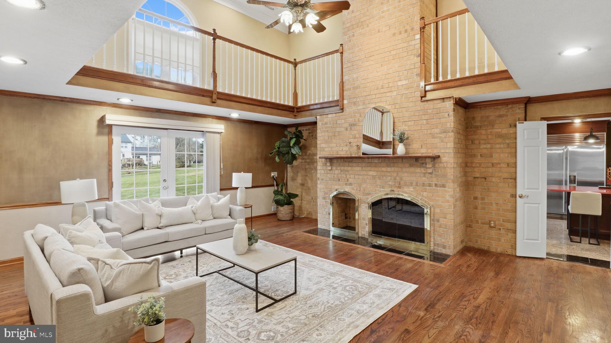 12302 Prospect Landing Bowie, MD 20721 - Photo 13 of 104 a living room with furniture a fireplace and a table
