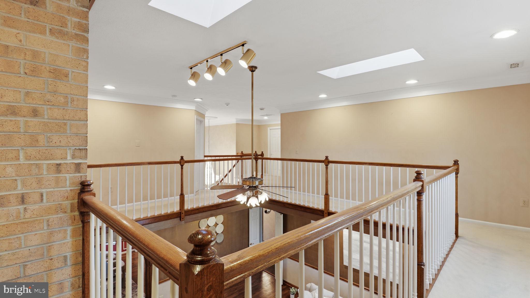 12302 Prospect Landing Bowie, MD 20721 - Photo 39 of 104 a view of staircase with railing and a chandelier