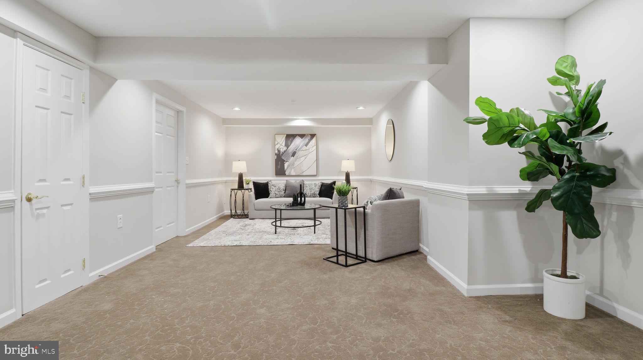 12302 Prospect Landing Bowie, MD 20721 - Photo 67 of 104 a living room with furniture a potted plant and a potted plant