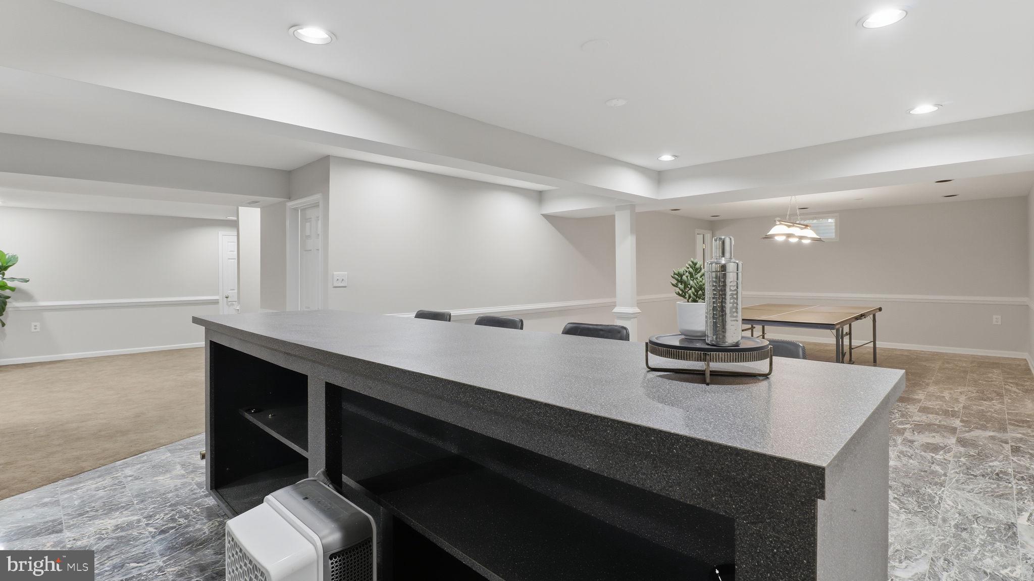 12302 Prospect Landing Bowie, MD 20721 - Photo 71 of 104 a kitchen with kitchen island a sink dishwasher a stove and a dining table with wooden floor