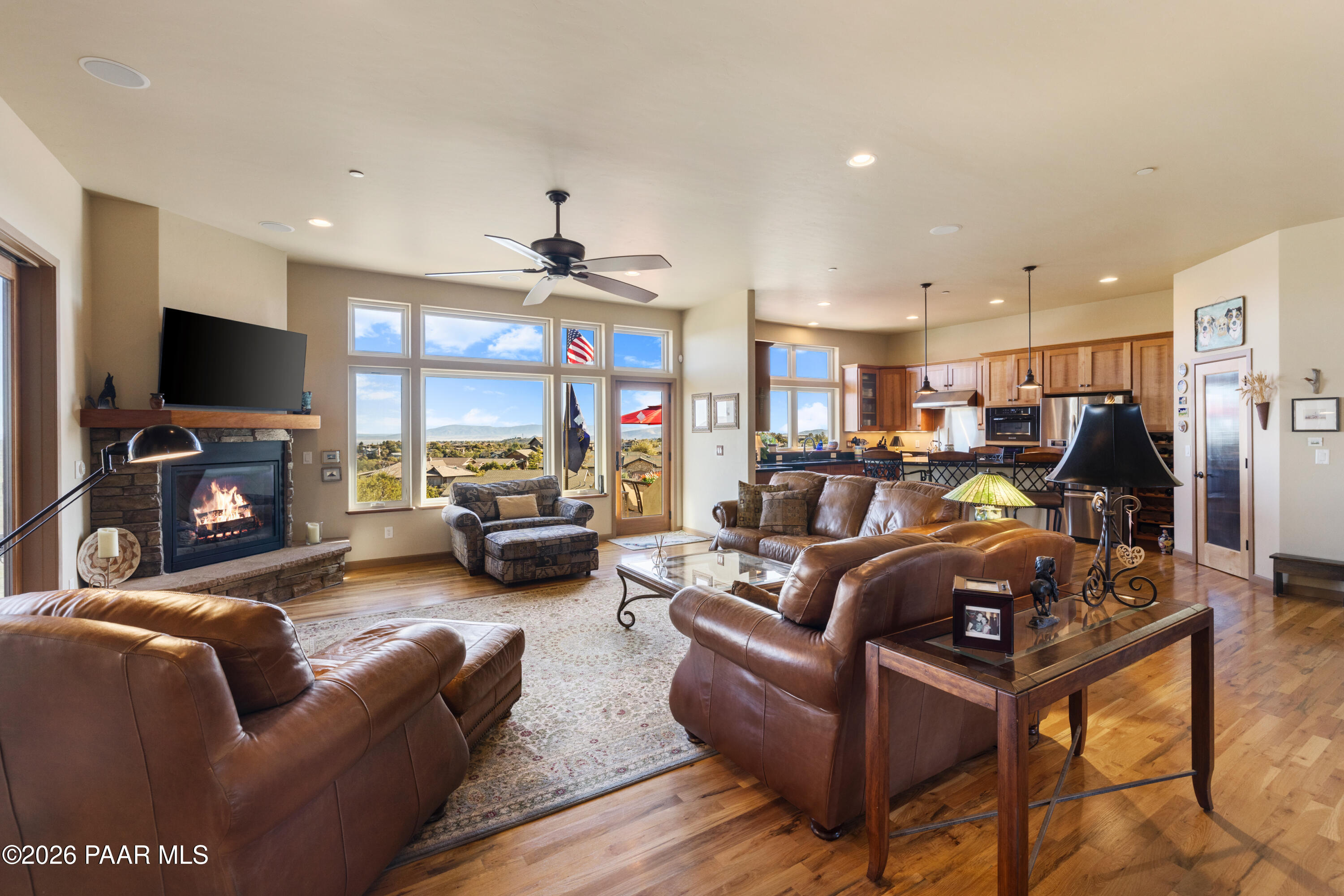 1448 Short Point Lane Prescott, AZ 86305 - Photo 16 of 56 a living room with furniture a flat screen tv and a fireplace