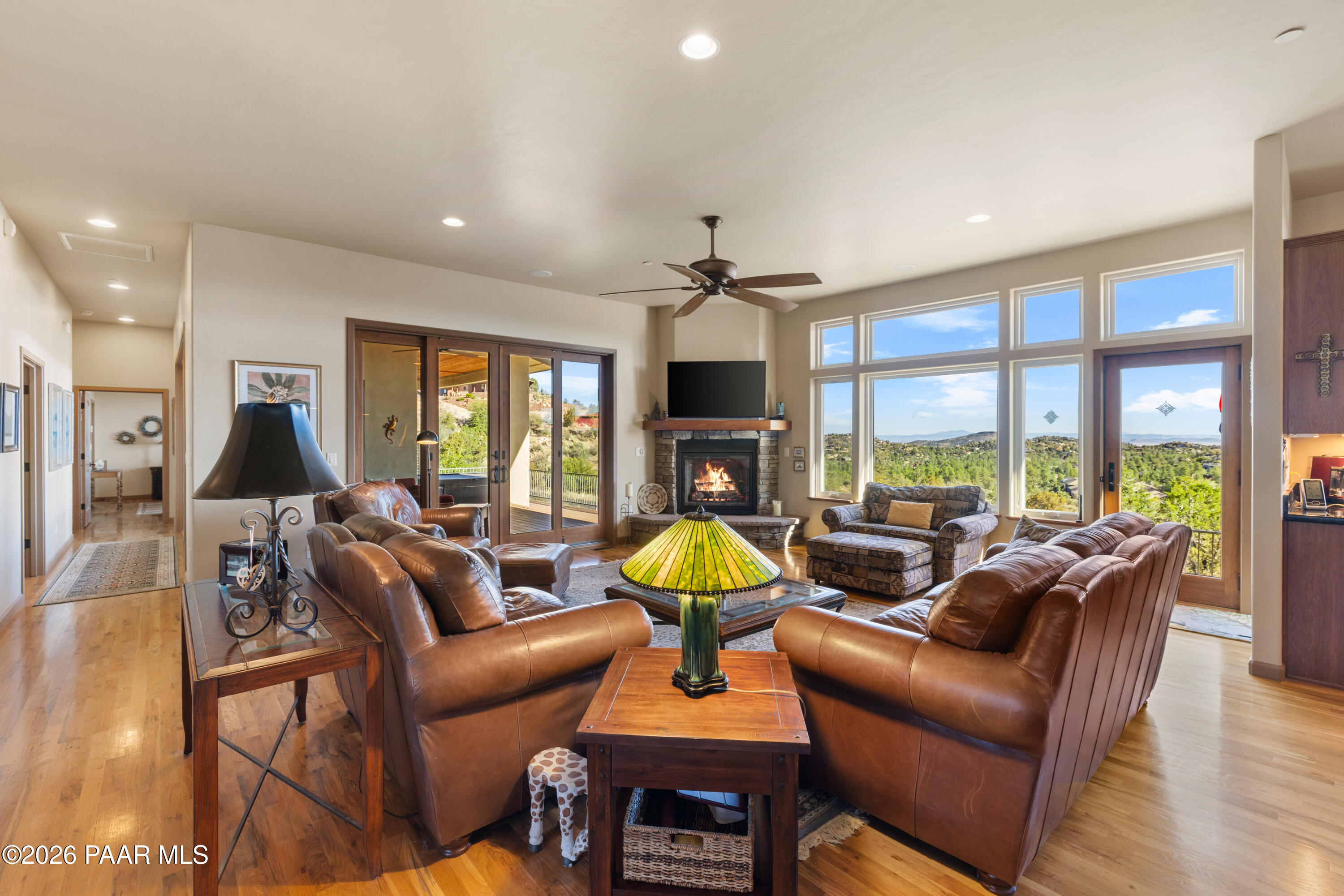 1448 Short Point Lane Prescott, AZ 86305 - Photo 17 of 56 a living room with furniture a fireplace a flat screen tv and a large window