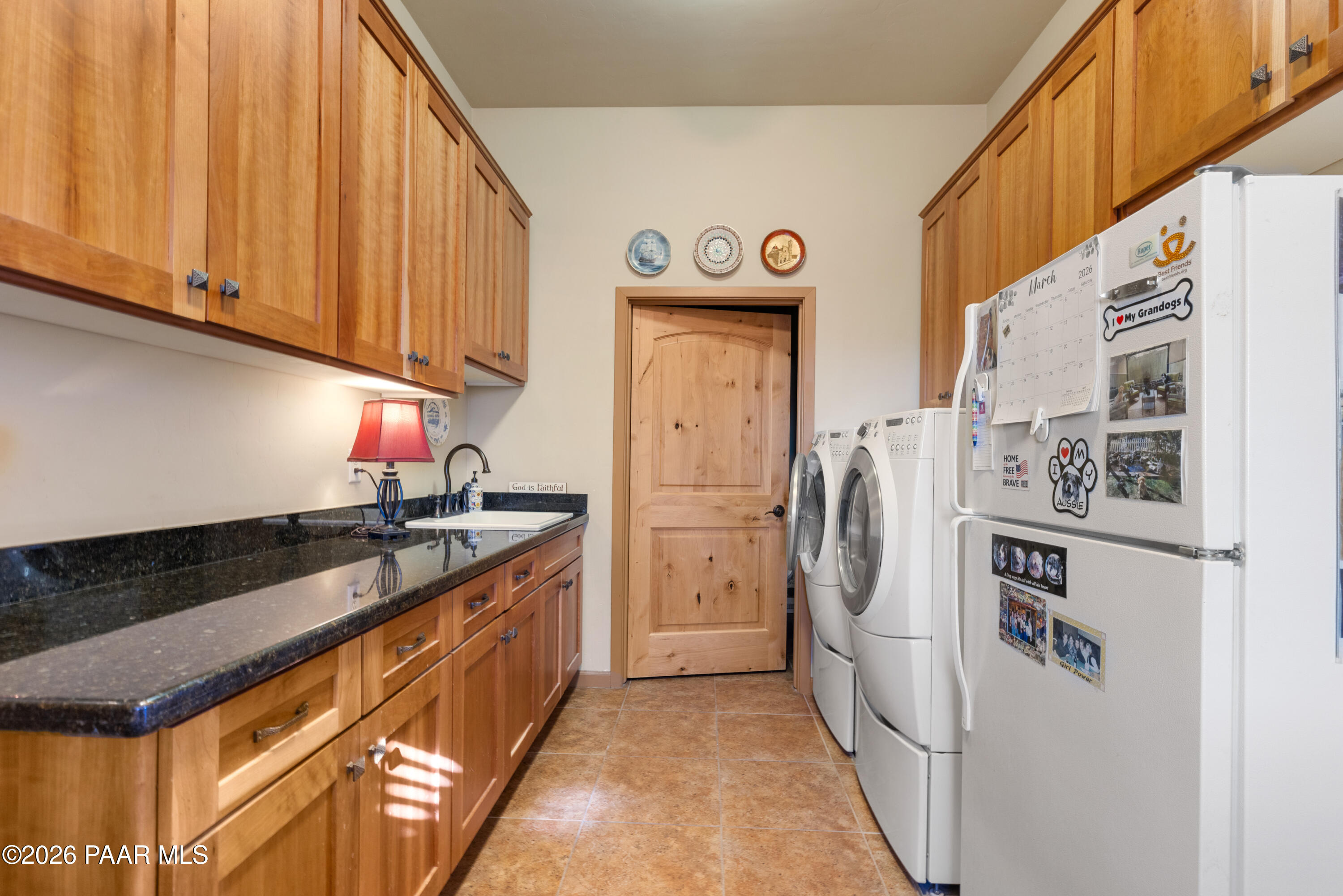 1448 Short Point Lane Prescott, AZ 86305 - Photo 26 of 56 a kitchen with stainless steel appliances granite countertop a refrigerator a stove and a sink