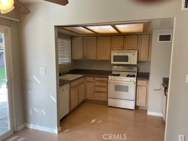 a kitchen with a stove a sink and a microwave