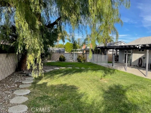 a view of backyard with swimming pool and trees