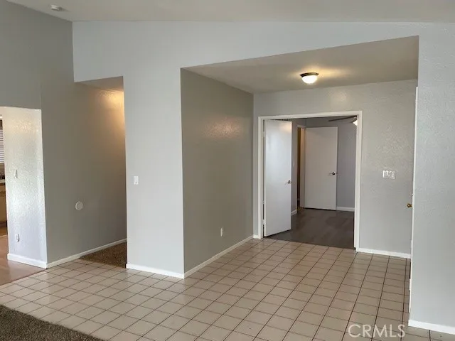 a view of a hallway to rooms