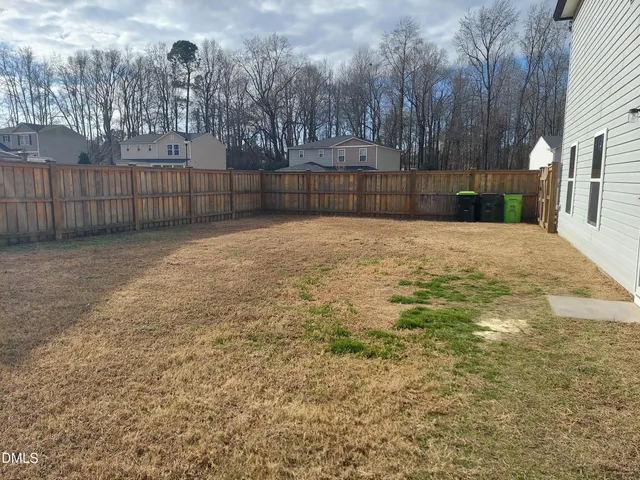 a view of outdoor space with wooden fence