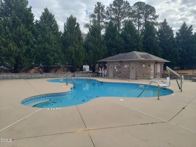 a view of pool with a yard