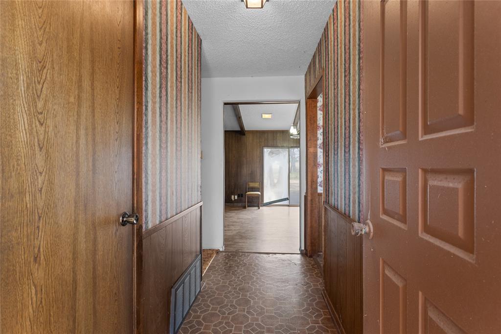 1447 Red Gate Road Mart, TX 76664 - Photo 25 of 38 a view of a hallway with wooden floor and staircase