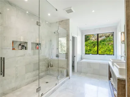 a bathroom with a bathtub and a shower