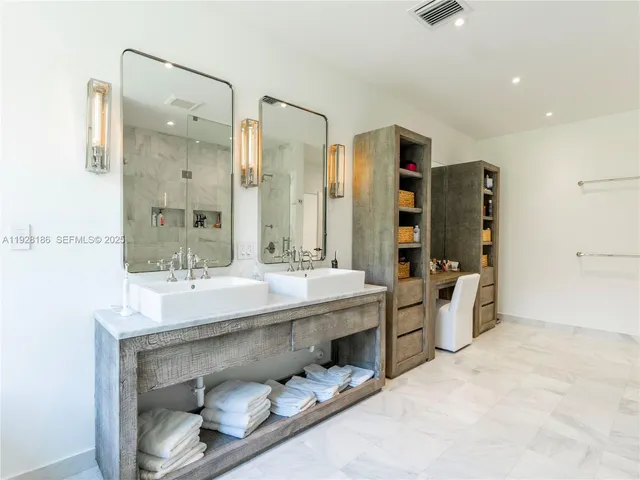 a bathroom with a double vanity sink mirror and double
