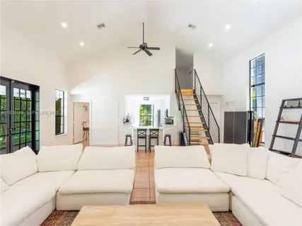 a large white bedroom with a large bed and furniture