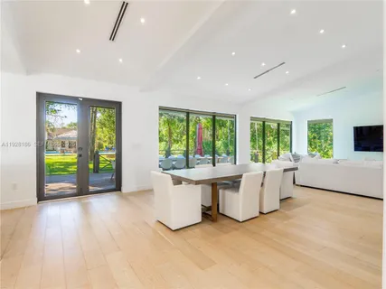 a living room with furniture and large windows