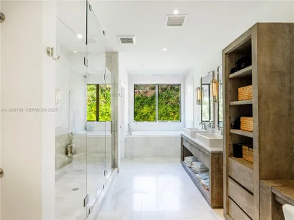 a bathroom with a tub shower and window
