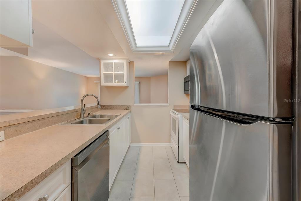 615 Garland Circle Indian Rocks Beach, FL 33785 - Photo 16 of 52 a kitchen with a refrigerator and a sink