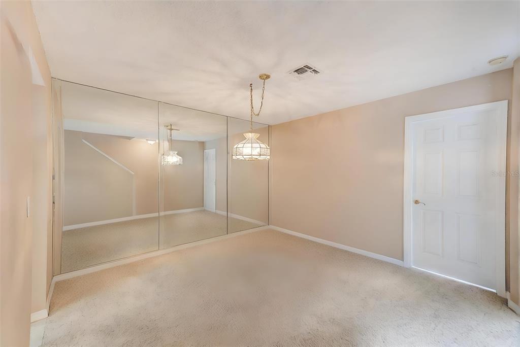 615 Garland Circle Indian Rocks Beach, FL 33785 - Photo 20 of 52 a view of an empty room with a chandelier fan