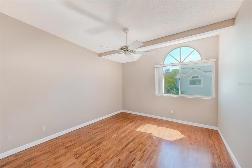 615 Garland Circle Indian Rocks Beach, FL 33785 - Photo 22 of 52 wooden floor in an empty room with a window