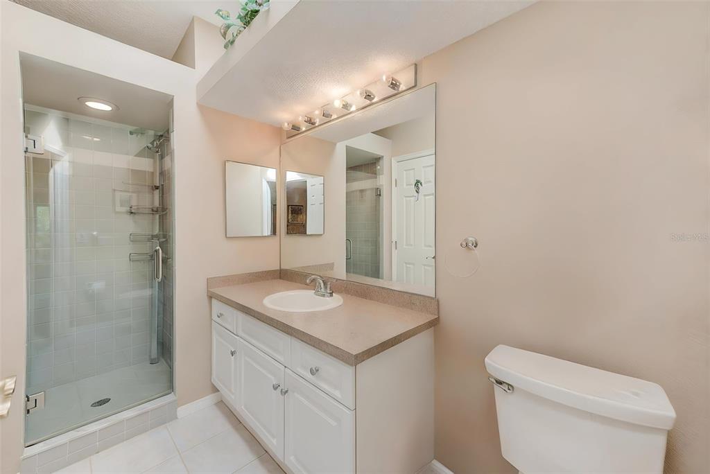 615 Garland Circle Indian Rocks Beach, FL 33785 - Photo 24 of 52 a bathroom with a granite countertop sink mirror and toilet