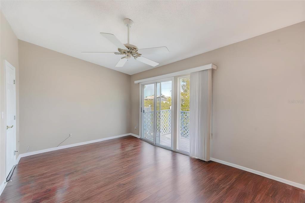 615 Garland Circle Indian Rocks Beach, FL 33785 - Photo 26 of 52 a view of an empty room with a window and wooden floor