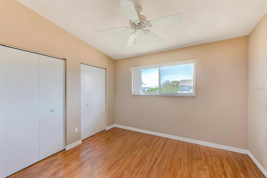 615 Garland Circle Indian Rocks Beach, FL 33785 - Photo 29 of 52 wooden floor in an empty room with a window