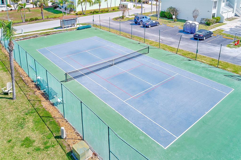 615 Garland Circle Indian Rocks Beach, FL 33785 - Photo 40 of 52 a view of a tennis ground with large trees