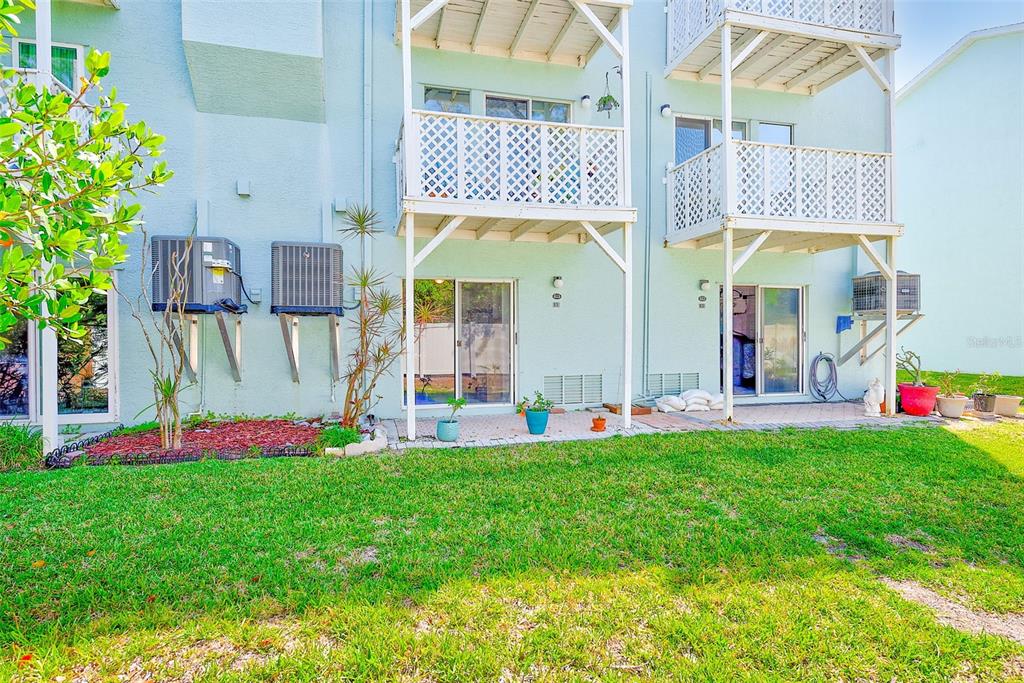 615 Garland Circle Indian Rocks Beach, FL 33785 - Photo 44 of 52 a front view of multi story residential apartment building with yard and swimming pool