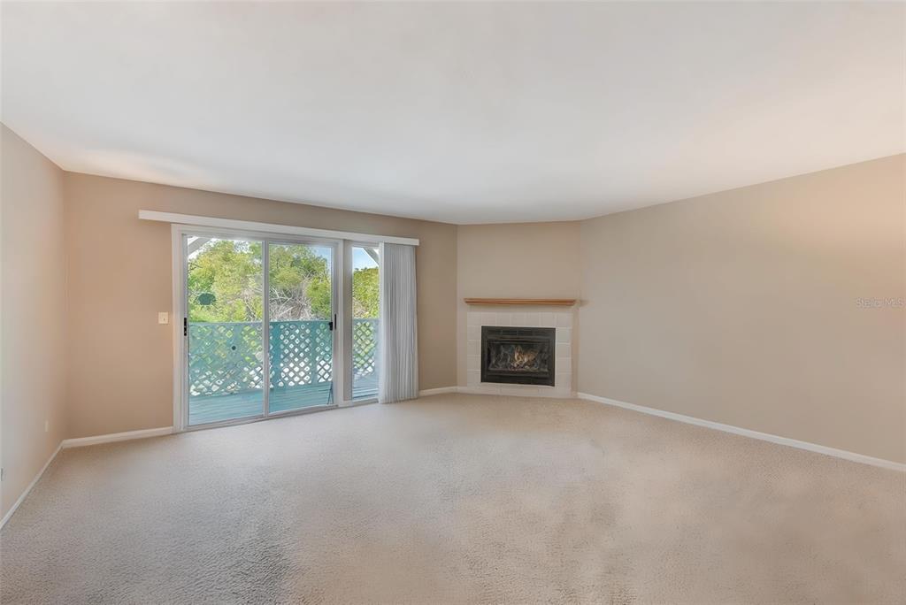 615 Garland Circle Indian Rocks Beach, FL 33785 - Photo 10 of 52 a view of an empty room with a fireplace and a window