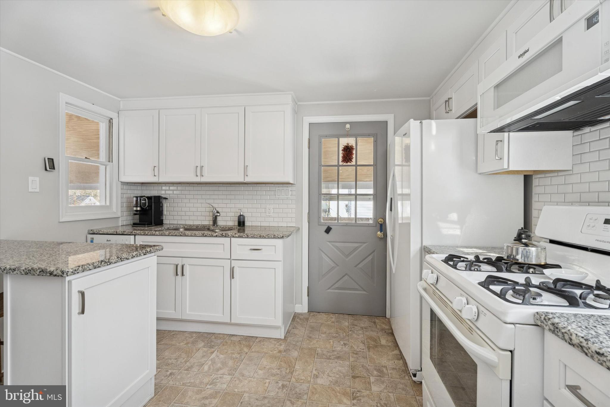 2305 Triebel Road Abington, PA 19001 - Photo 7 of 19 a kitchen with stainless steel appliances granite countertop a stove a sink and a refrigerator