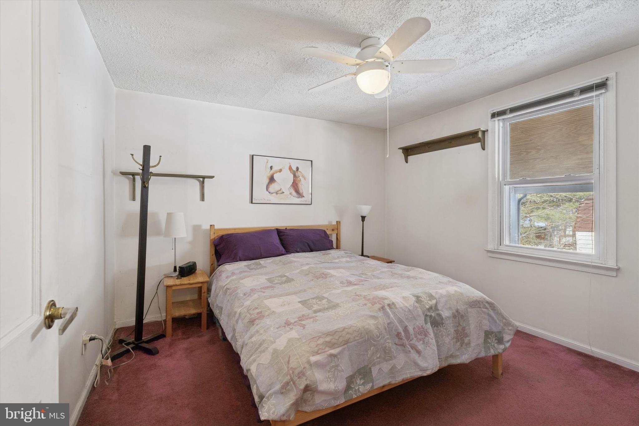 2305 Triebel Road Abington, PA 19001 - Photo 9 of 19 a bedroom with a bed and a chandelier