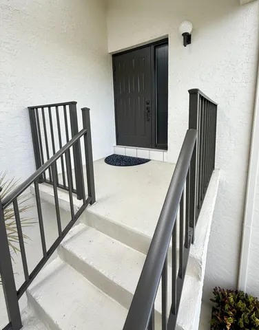 a view of an entryway with wooden floor