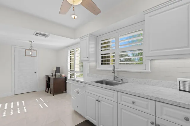 a bathroom with double sink and a window