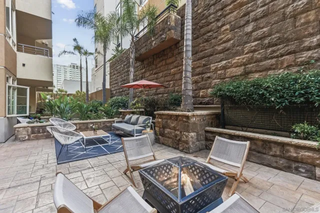 a view of a patio with table and chairs and potted plants