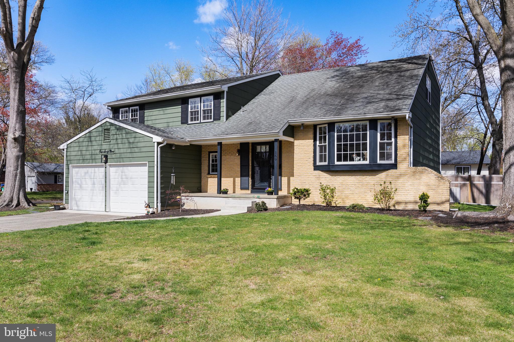 169 Canterbury Road Mount Laurel, NJ 08054 - Photo 2 of 47 a front view of a house with a garden and trees