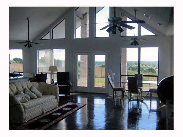 a living room with furniture wooden floor and a large window