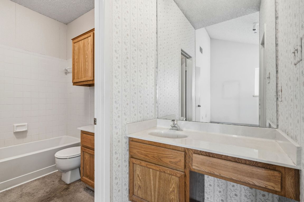 6501 Brush Country Road, Unit 120 Austin, TX 78749 - Photo 24 of 35 Bathroom with a textured ceiling and vanity