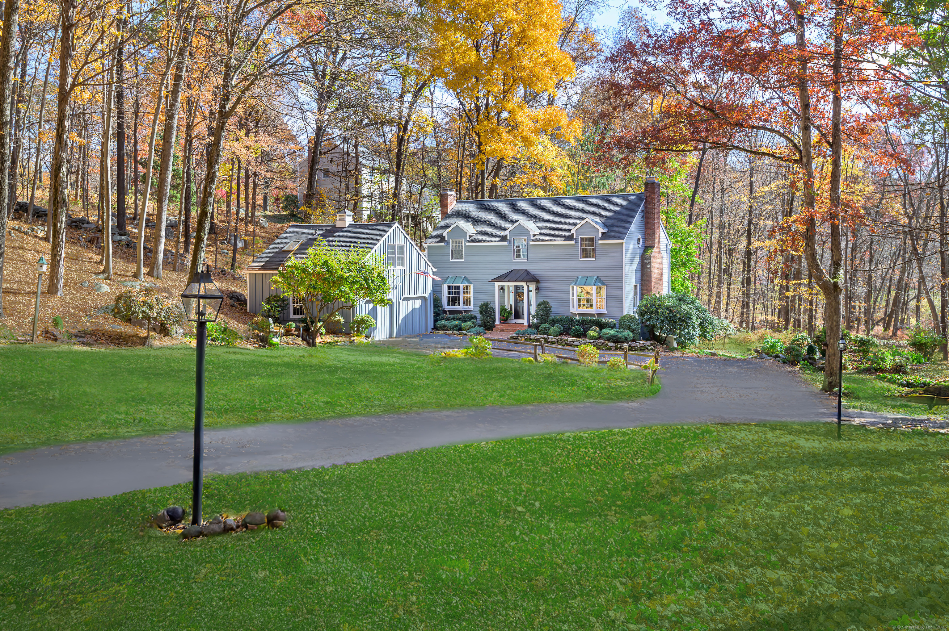 a view of a house with a big yard and a large tree