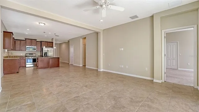 a large kitchen with kitchen island granite countertop a sink and a stove
