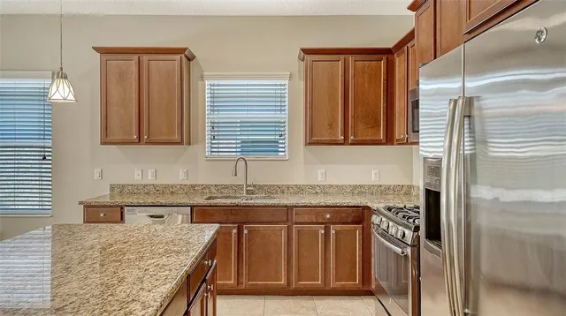 a kitchen with granite countertop a sink and a window