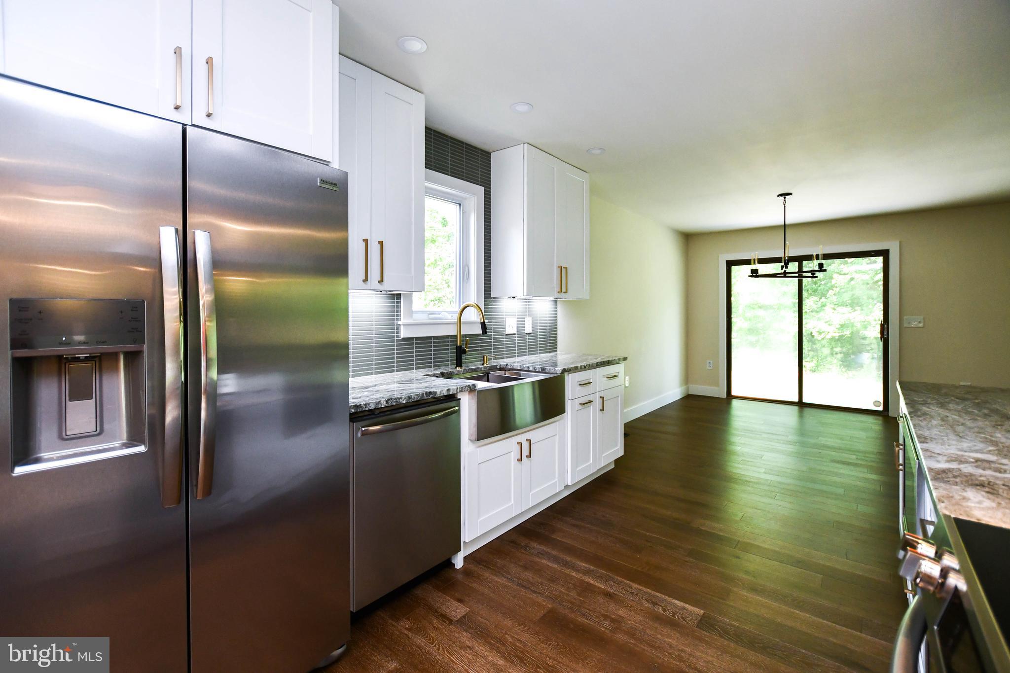 1423 Albert Drive Bowie, MD 20721 - Photo 27 of 86 a kitchen with stainless steel appliances granite countertop a refrigerator a stove and a wooden floors