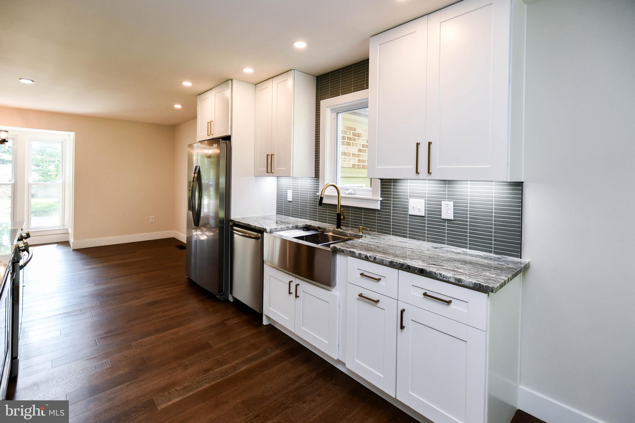 1423 Albert Drive Bowie, MD 20721 - Photo 29 of 86 a kitchen with stainless steel appliances granite countertop a stove a sink and a refrigerator