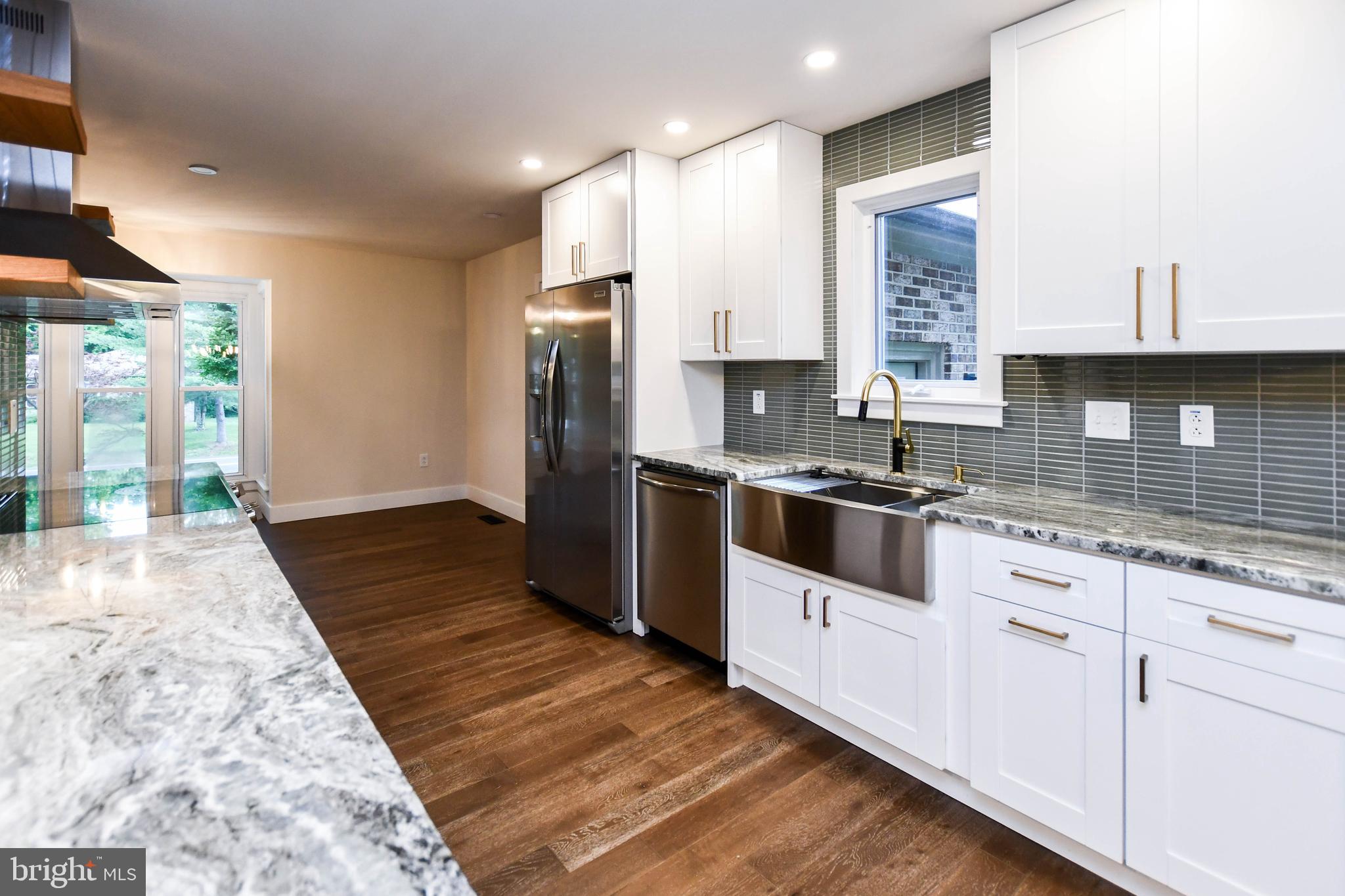 1423 Albert Drive Bowie, MD 20721 - Photo 33 of 86 a kitchen with granite countertop a sink a counter top space and cabinets