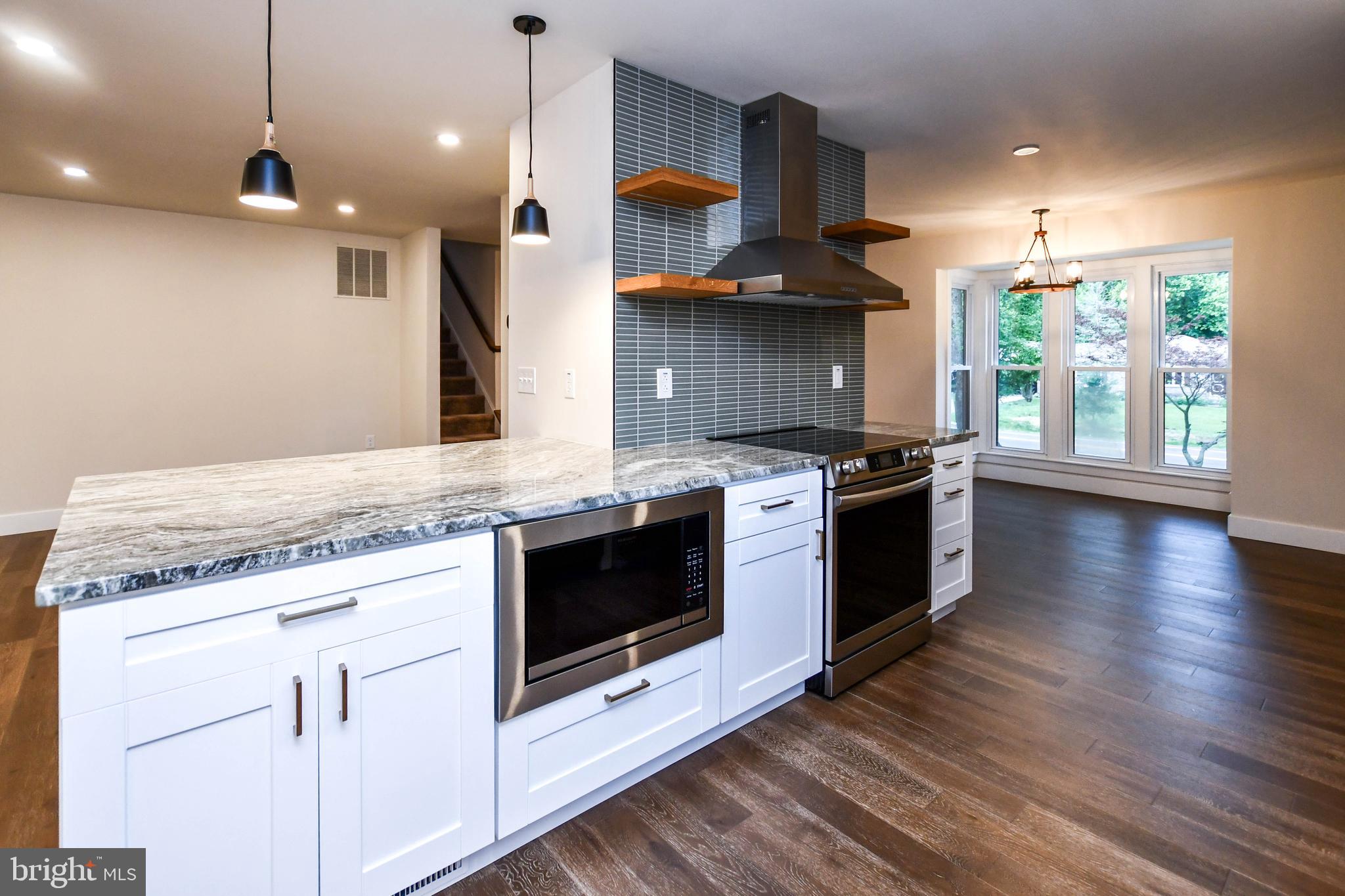 1423 Albert Drive Bowie, MD 20721 - Photo 34 of 86 a kitchen with stainless steel appliances granite countertop a stove a sink and a microwave