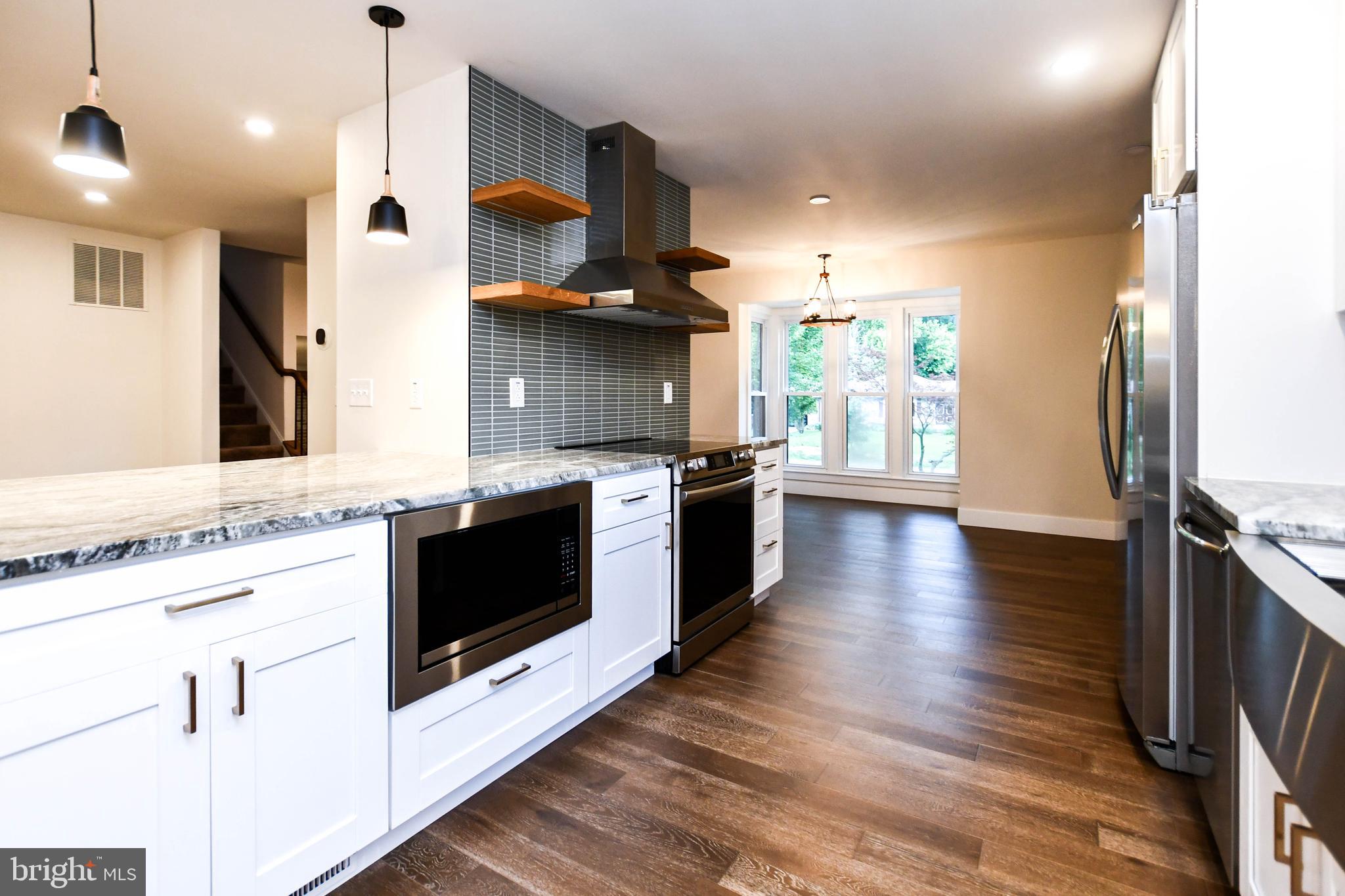 1423 Albert Drive Bowie, MD 20721 - Photo 35 of 86 a large kitchen with stainless steel appliances granite countertop a stove and a wooden floors