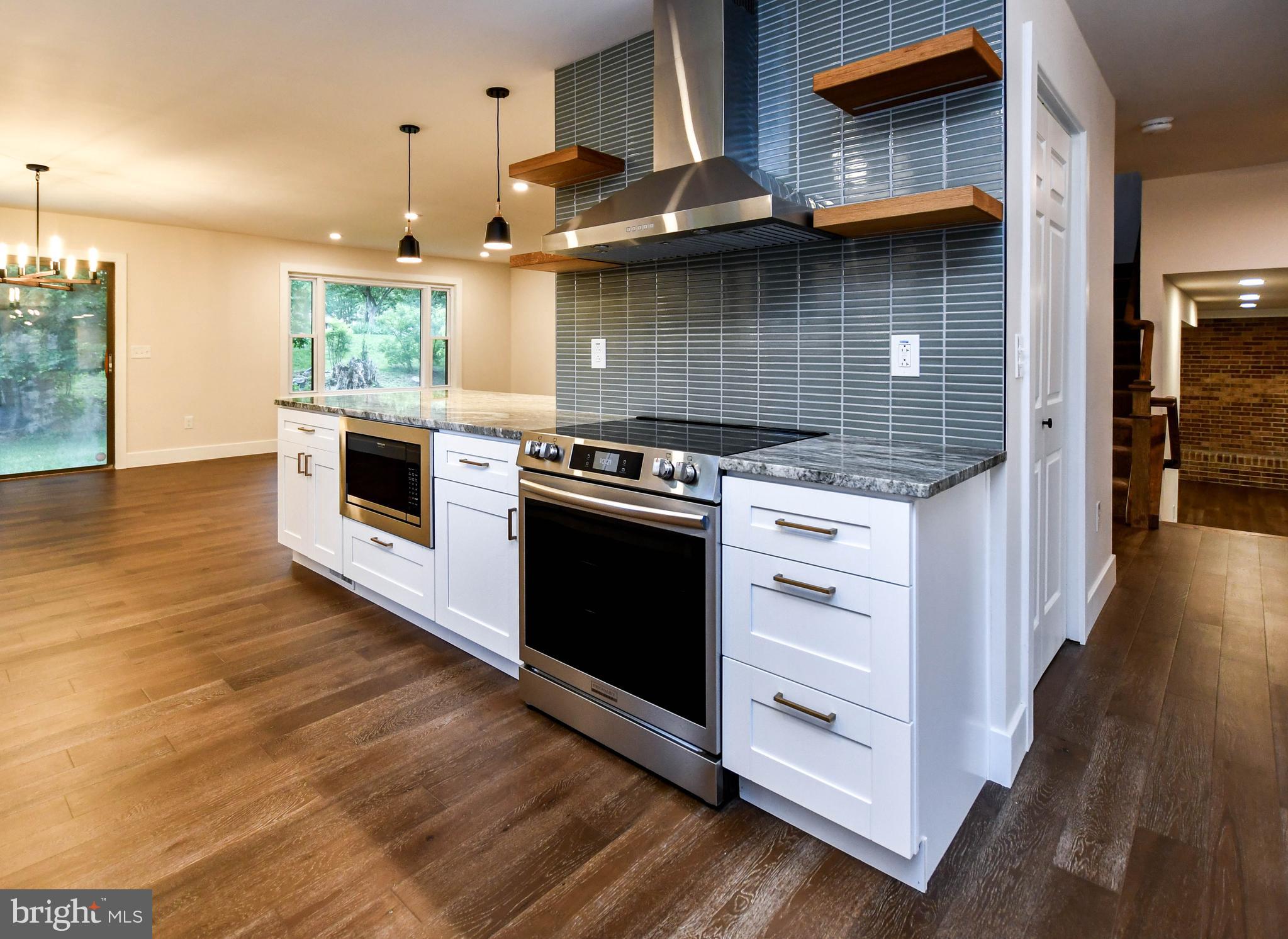 1423 Albert Drive Bowie, MD 20721 - Photo 36 of 86 a kitchen with a stove and a wooden floor