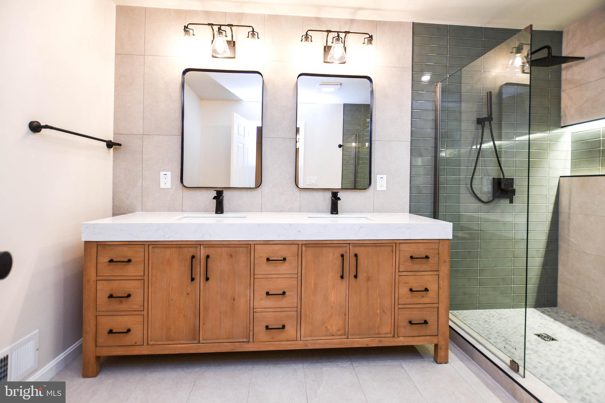 1423 Albert Drive Bowie, MD 20721 - Photo 52 of 86 a bathroom with a double vanity sink a mirror and a shower