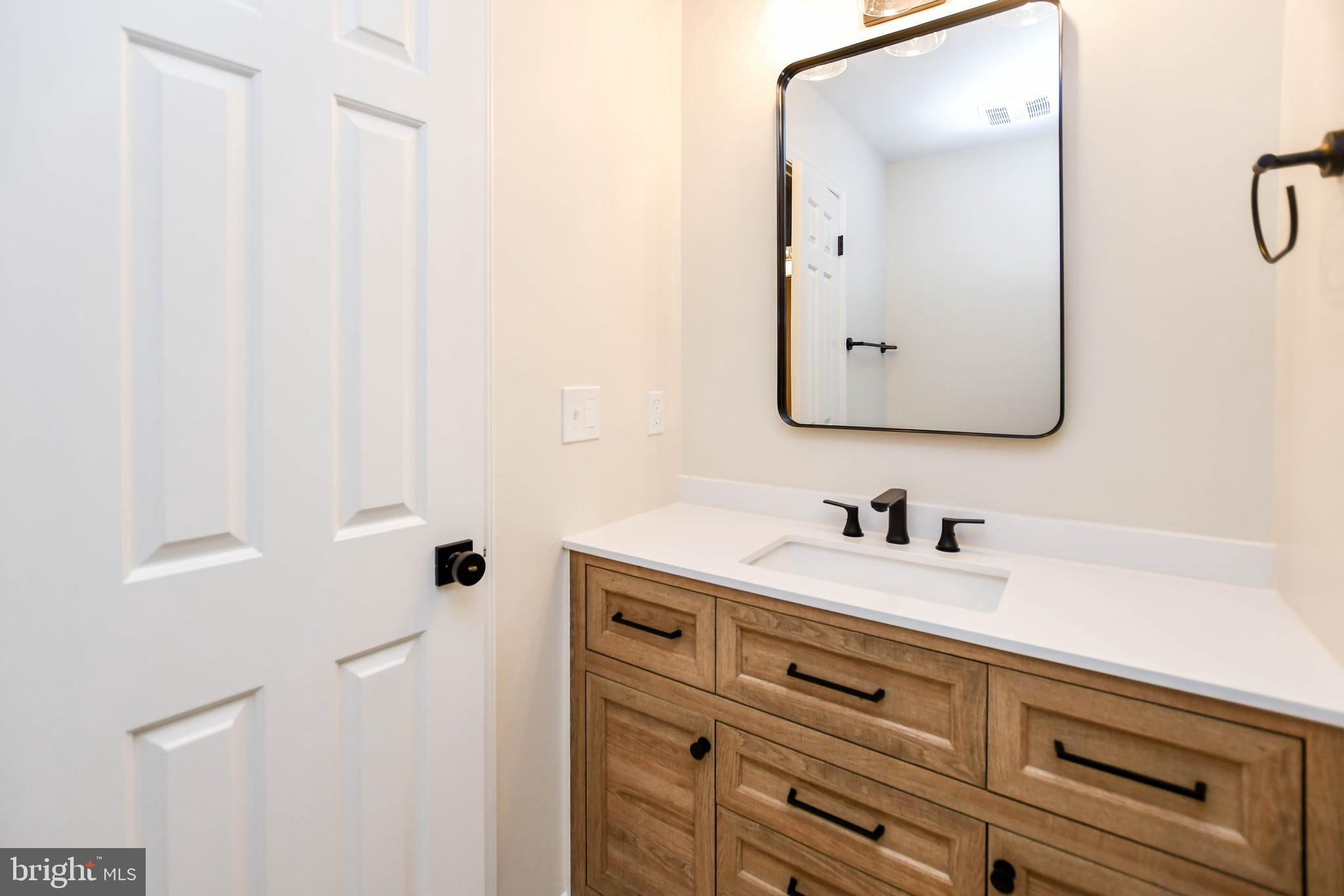 1423 Albert Drive Bowie, MD 20721 - Photo 63 of 86 a bathroom with a sink vanity and mirror