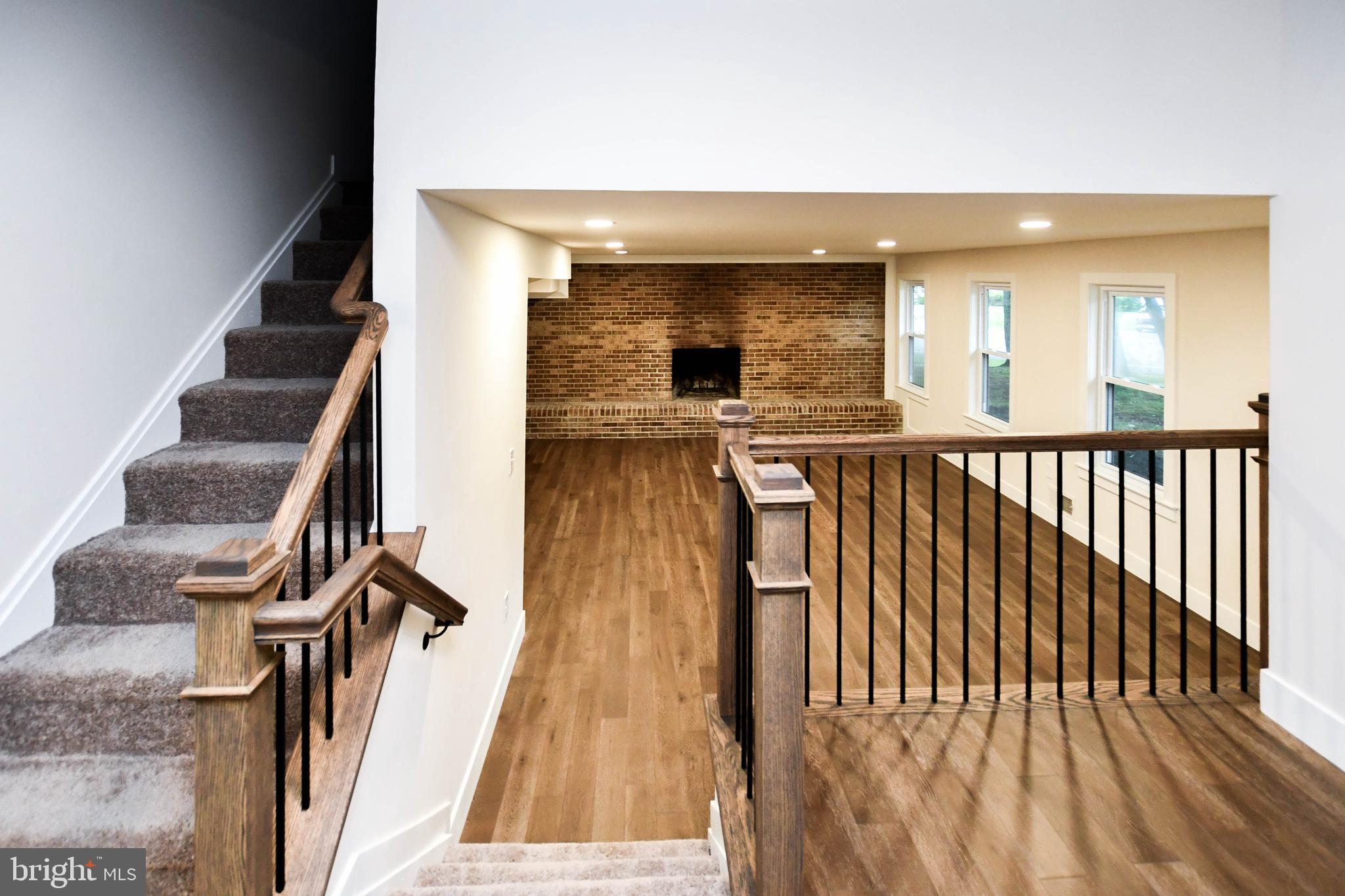 1423 Albert Drive Bowie, MD 20721 - Photo 67 of 86 a view of a hallway with wooden floor and staircase