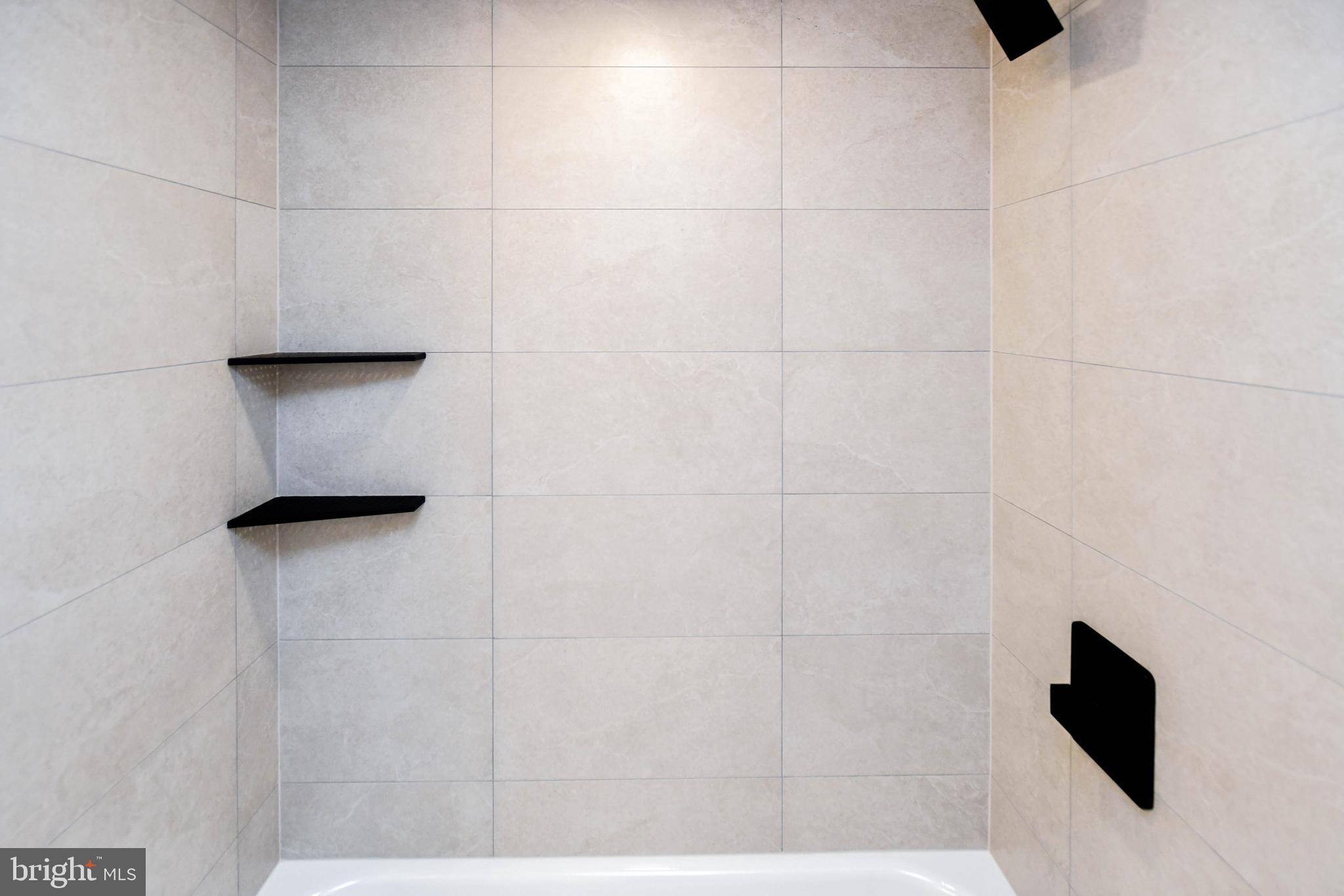 1423 Albert Drive Bowie, MD 20721 - Photo 78 of 86 a bathroom with a shower a sink and a mirror