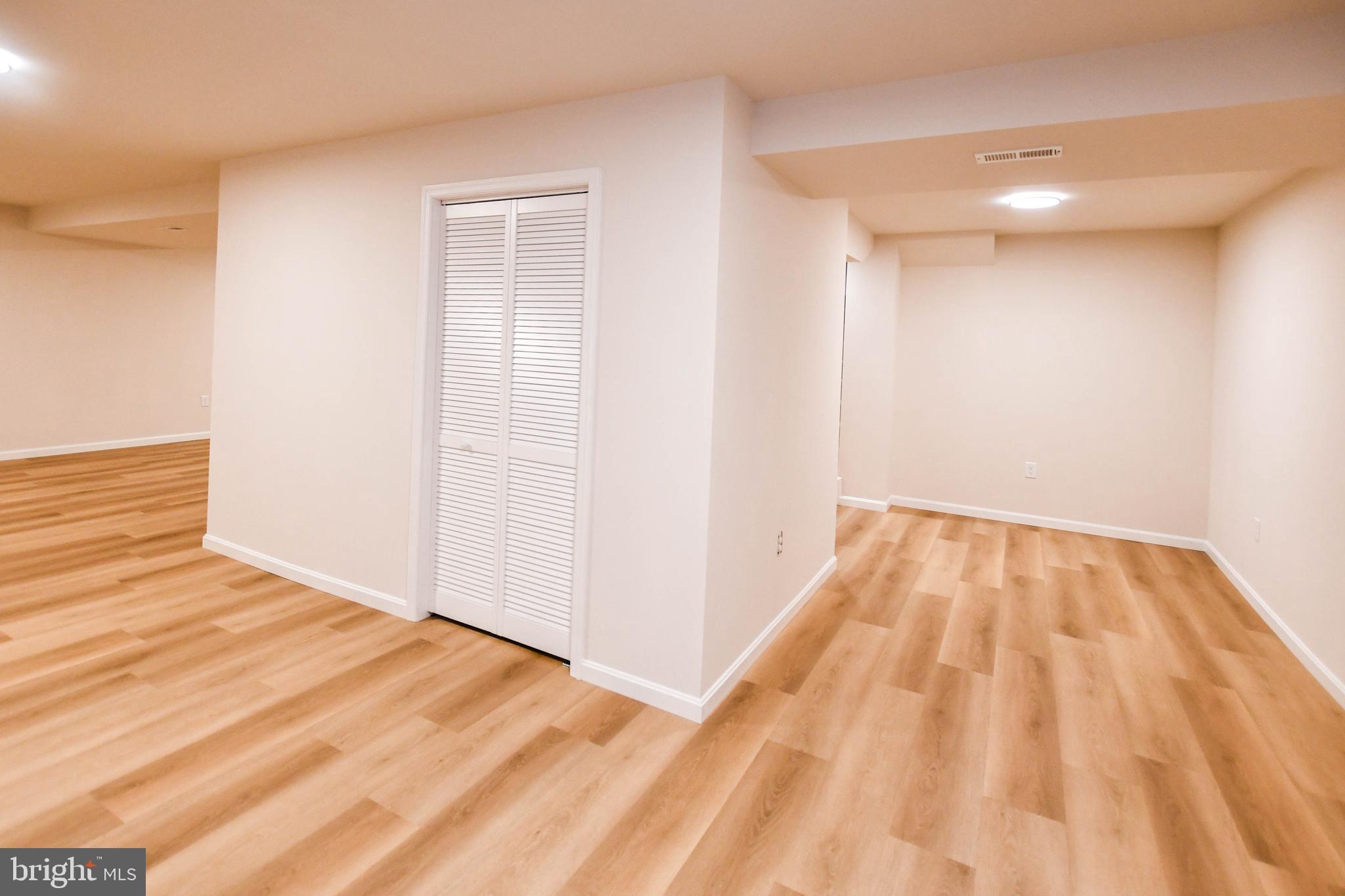 1423 Albert Drive Bowie, MD 20721 - Photo 83 of 86 a view of a room with wooden floor and a bathroom